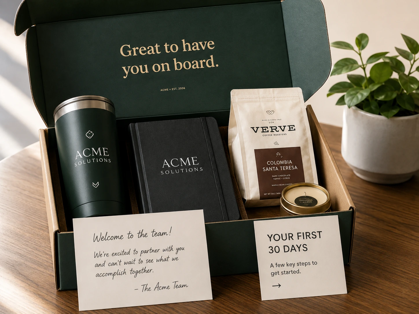 A premium new-customer welcome kit with a tumbler, notebook, coffee, candle, welcome note, and first-30-days card